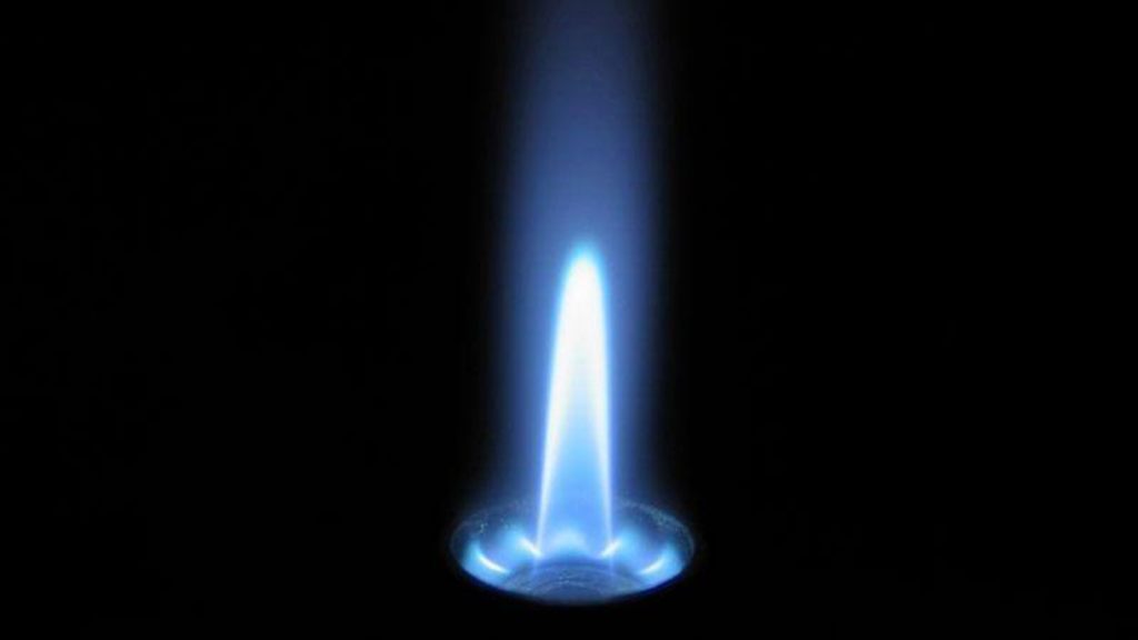 Blue pilot light on black background