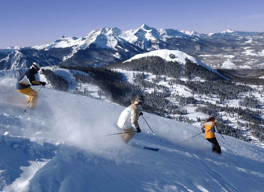 Three people skiing on a mountain
