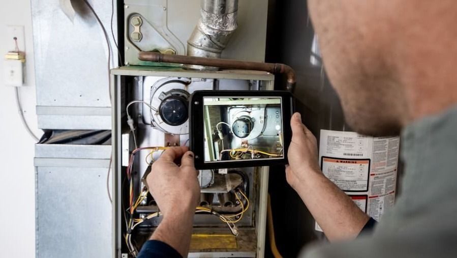 HVAC technician inspecting a furnace